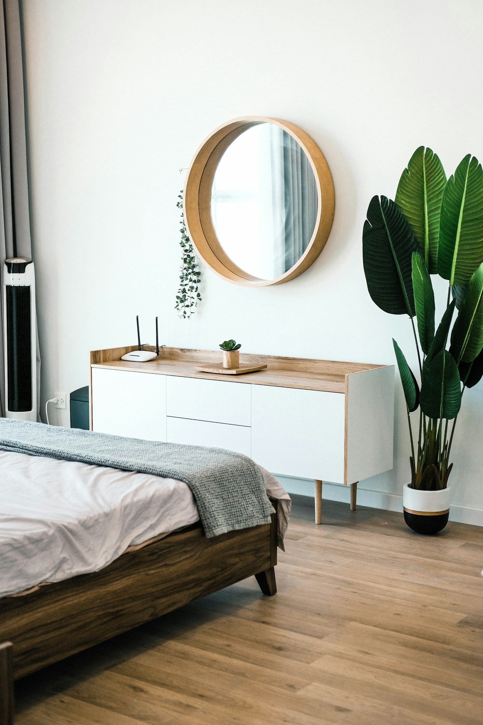 White wooden dresser with mirror in bedroom