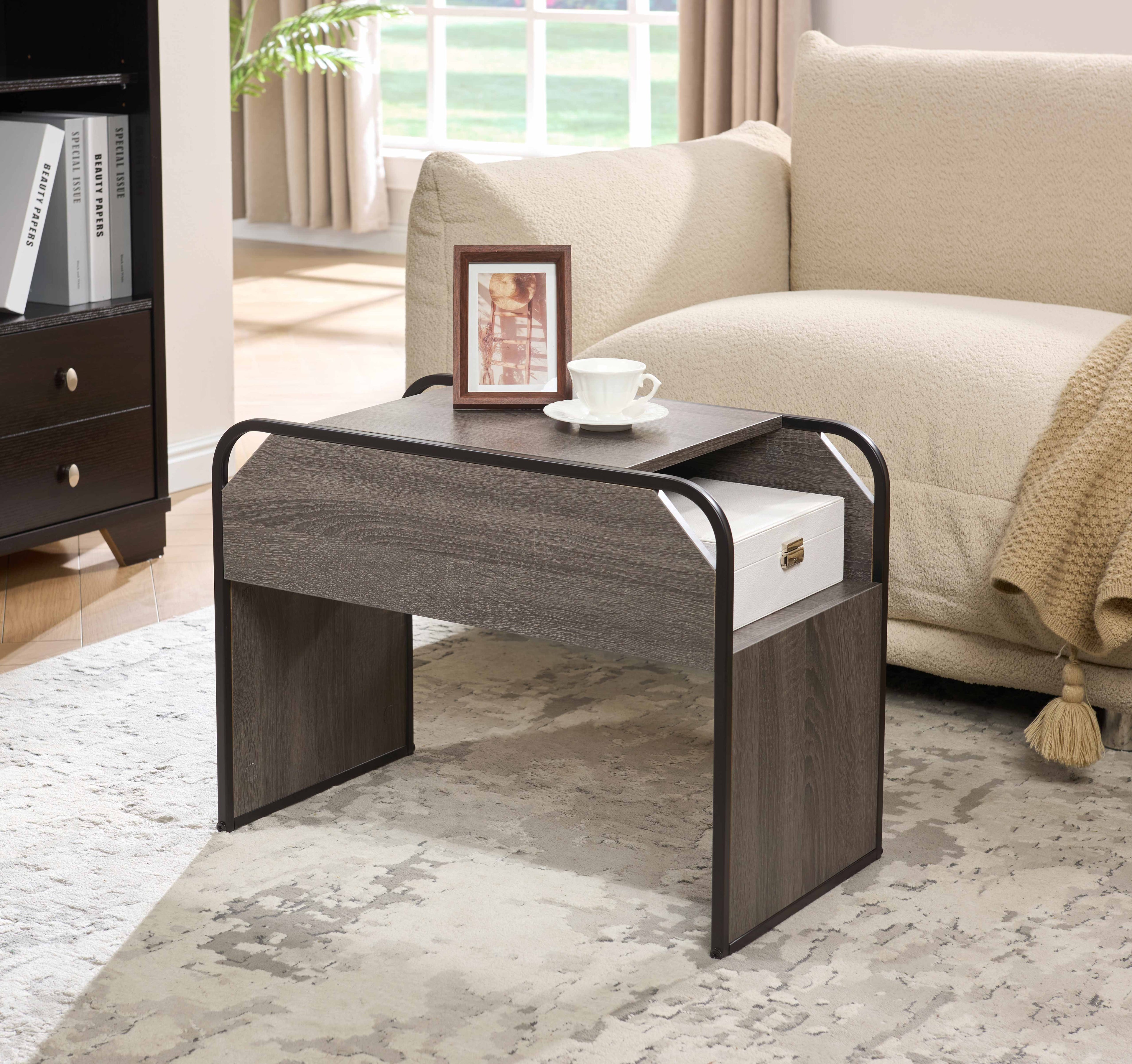 Carlaw C-shape side table in grey oak sliding under a sofa